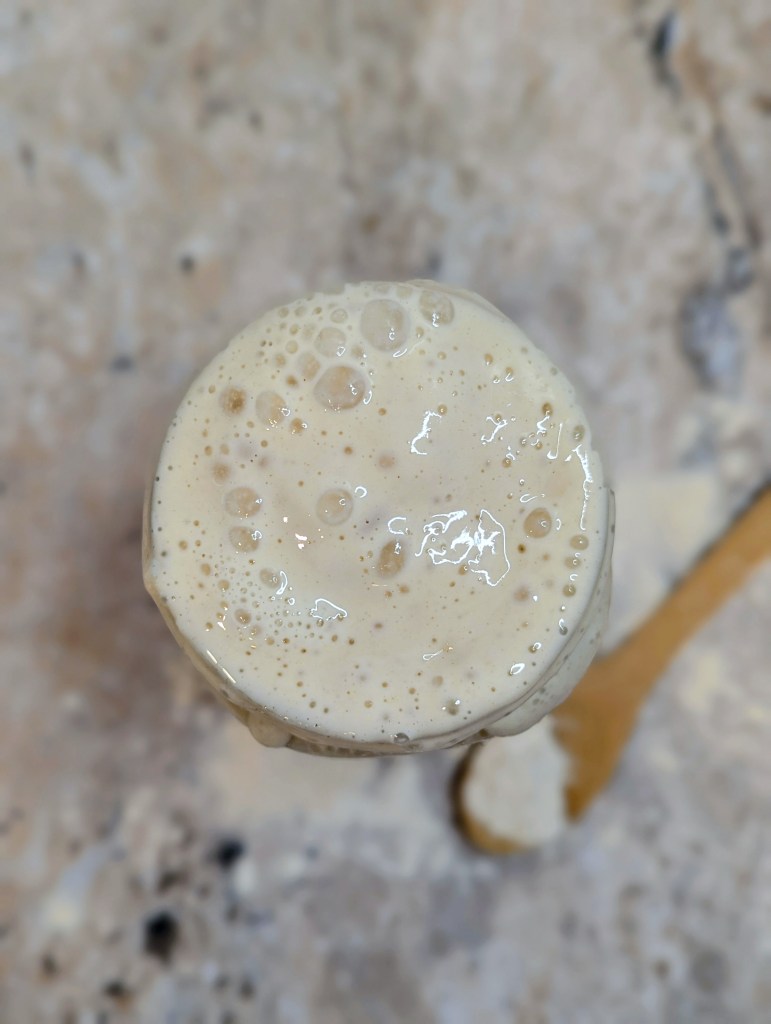 Bubbly sourdough starter in a glass jar